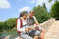 Backpackers reading map on the stone bridge Royalty Free Stock Photo