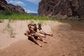 Backpackers resting by the Colorado River in the Grand Canyon.