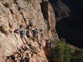 Backpackers on a steep, narrow trail in the Grand Canyon.