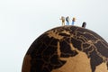 Backpackers on top of the Globe. Travel concept