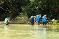 Backpackers walk across the water Royalty Free Stock Photo