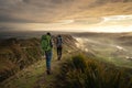 Backpackers walking on a mountain at sunrise. Travel concept Royalty Free Stock Photo