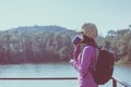 Backpacking Asian woman drinking hot coffee in the morning at outdoor,Camping hiking concept Royalty Free Stock Photo