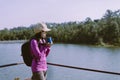 Backpacking asian woman hands holding a glass of warm coffee in the morning at outdoor,Camping hiking concept Royalty Free Stock Photo