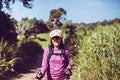 Backpacking Asian woman standing while looking something in the morning at outdoor,Happy and smiling,Camping hiking concept Royalty Free Stock Photo