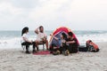 Backpacking group, Asian men and women, partying, chatting and drinking fun, tent camping on the beach, seaside, outdoor adventure Royalty Free Stock Photo