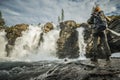 Backpacking Hiker in Front of a Scenic Waterfall