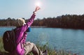 Backpacking woman hands holding a glass of warm coffee in the morning at outdoor,Lifestyle outdoor concept Royalty Free Stock Photo