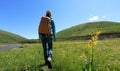 Woman hiking in high land grassland mountains