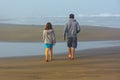 Father Daughter Stroll Beach in Quiet Conversation Royalty Free Stock Photo
