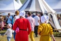 Backs of two young women in the medieval dresses at the international knight festival Tournament of Saint George