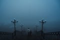 backs of a woman with a child boy going down the stairs on a foggy bridge in city on an autumn morning in fog mist Royalty Free Stock Photo