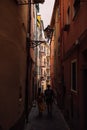 Backshot of a couple wandering on the narrow street of Manarola, a perfect destination for honeymoon