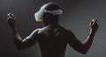 Backside of African male muscular athlet with naked torso using vr headset Royalty Free Stock Photo