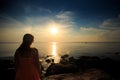 Backside Blond Girl Watches Sunset over Sea