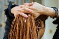 Backside dreadlocks head closeup, fashionable girl posing at old wooden door background