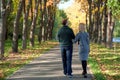 Backside of girl and guy hand in love. love, relationship, family and people concept - happy couple walking in summer