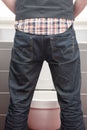 Backside of man urinating standing up Royalty Free Stock Photo