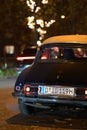 Backside of an old black Citroen DS classic car at night in Duesseldorf, Germany.