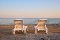 Backside view two beach chairs in the evening. Royalty Free Stock Photo