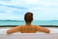 Backside woman in bathtub on sea view