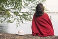 Backside of woman sitting on tree in front of a lake Royalty Free Stock Photo