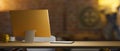 Backside of yellow computer desktop with copy space low light, vintage brick wall in the background