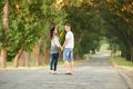 Backside of young couple walk on country road outdoor, romantic people concept, summer season Royalty Free Stock Photo