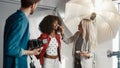 Backstage of the Photo Shoot: Make-up Artist Applies lipstick Makeup on Beautiful Black Royalty Free Stock Photo