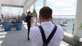 Backstage photography of bride and groom on the terrace of a multi-storey hotel