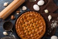 The backstage of preparing homemade pie witch mushrooms. The rolling pin. some eggs. fork. black pepper. garlic isolated on brown