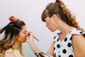 Backstage scene: Professional Make-up artist doing glamour model makeup at work Royalty Free Stock Photo