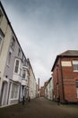 Backstreets of Weymouth old harbour with Brewers Quay building in distance, a coastal