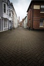 Backstreets of Weymouth old harbour with Brewers Quay building in distance, a coastal