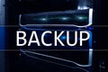 Backup button on modern server room background. Data loss prevention. System recovery