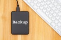 Backup your computer message with a black portable hard drive Royalty Free Stock Photo