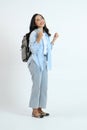backview full leght shoot of happy asian Indonesian woman wearing casual attire and backpack on isolated background