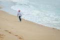 Backview of kid in Santa hat running on sunny