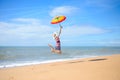 Backview of pretty woman jumping with umbrella on Royalty Free Stock Photo