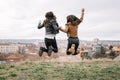 Backview of two girls in the air with hands clasped Royalty Free Stock Photo