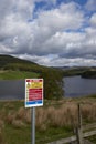 Backwater, Scotland-12th May 2019:A Be Aware warning Sign near to Backwater Reservoir, mentioning the consequences of swimming ing