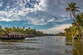 Backwater view with houseboats and palm tree