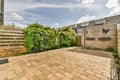 a backyard with a brick patio and a wooden fence Royalty Free Stock Photo