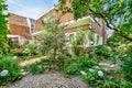 a backyard with a brick house and a garden Royalty Free Stock Photo