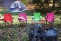 Backyard camping cooking hot dogs over a fire pit