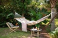 backyard escape with hammock, books and iced tea for a tranquil getaway