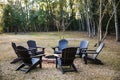 A backyard fire pit in a spacious yard of a large home