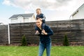 Father carrying baby son on the shoulders outdoors Royalty Free Stock Photo