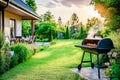 Backyard garden with barbecue grill at sunset Royalty Free Stock Photo