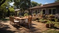 Backyard garden patio wooden table and chair full of flowers and green with warm light Royalty Free Stock Photo